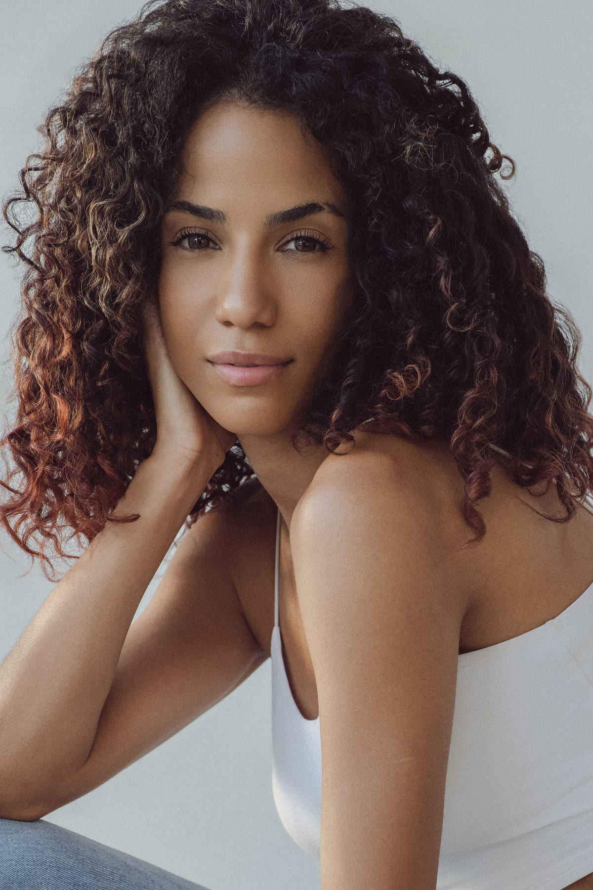 Close headshot of Christal resting her cheek on her hand
